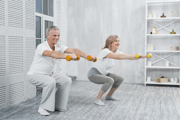 smiling-elder-couple-performing-exercise-with-dumbbells-home_23-2148097466.jpg